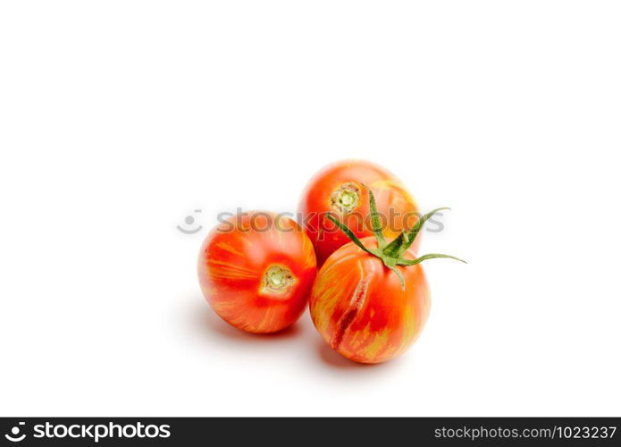 Three juicy red zebra tomatoes, isolated on white background