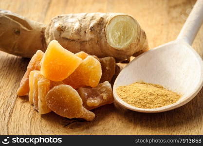 Three kinds of ginger - ground spice fresh and candied on rustic table. Healthy eating, home remedy for nausea upset stomach colds.