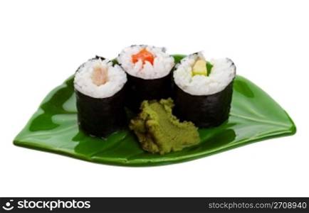Three kinds of sushi on a leaf shaped plate. Shot on white background.