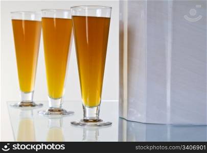 Three large beer glass filled with fresh Amber Beer