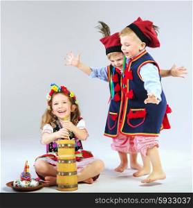 Three little children wearing traditional costumes