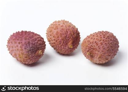 Three lychees on white background