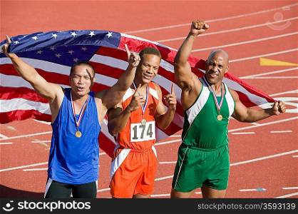 Three male athletes enjoying victory, portrait