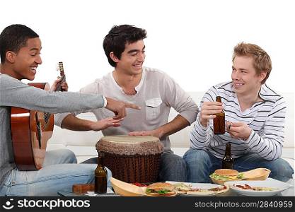 Three male friends playing instruments