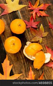 Three mandarins with autumn leaves, season?s fruit