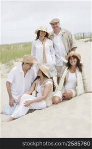 Three mature women with two mature men on the beach