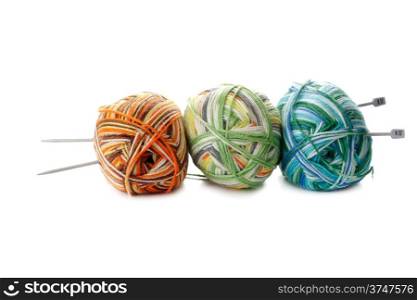 three melange ball of wool and knitting needles on white background