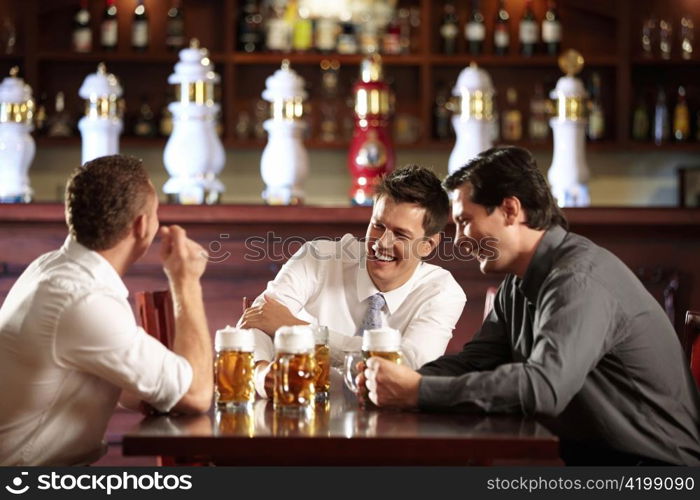 Three men in shirts in the bar