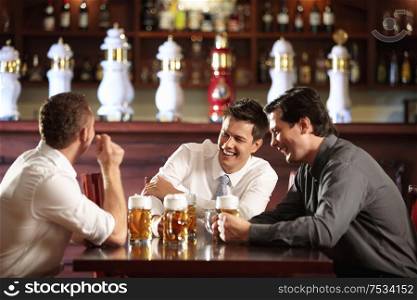 Three men in shirts in the bar