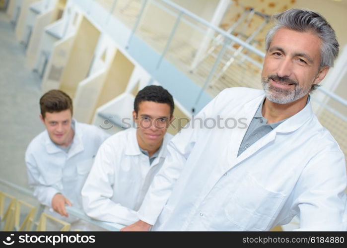 three men in white uniform