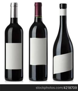 Three merged photographs of different shape red wine bottles with blank labels. Separate clipping paths for bottles and labels included.