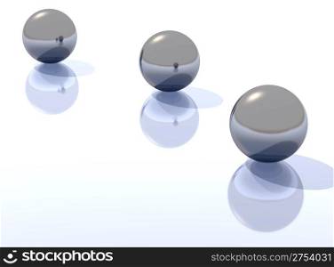 Three metal spheres with a shadow on a surface and reflection in each other