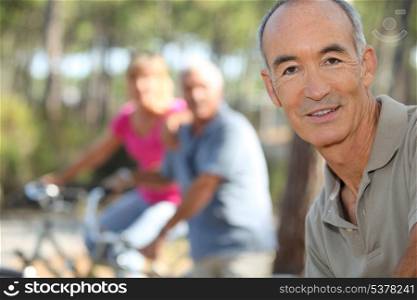 Three middle-aged people on bike ride