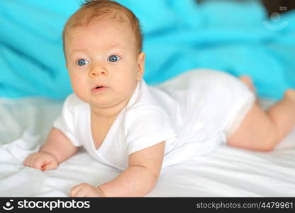 Three months old baby in bed