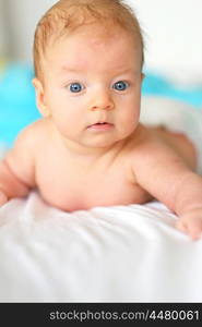 Three months old baby in bed