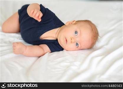Three months old baby in bed
