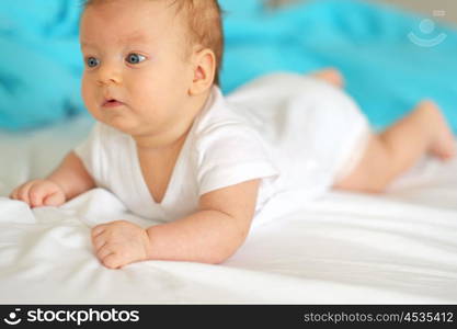 Three months old baby in bed