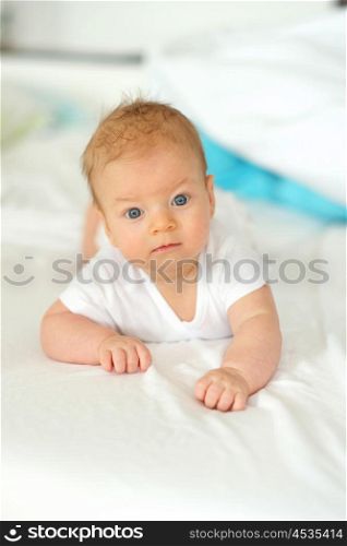 Three months old baby in bed