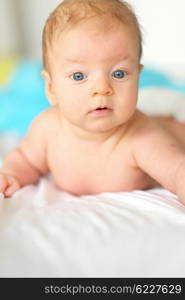 Three months old baby in bed