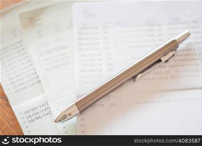 Three of bank account passbooks with pen, stock photo