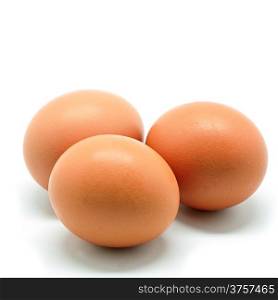 Three of brown chicken egg isolated on a white background