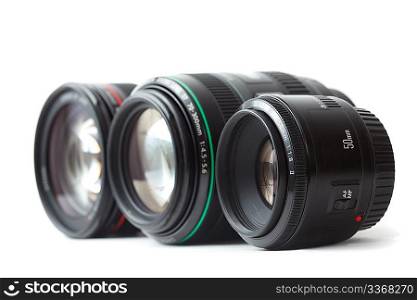 Three of lens to camera put in row. Isolated on white background. Focus on the front lens.
