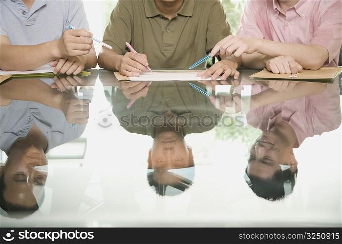 Three office workers discussing in a meeting