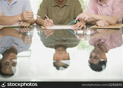 Three office workers discussing in a meeting