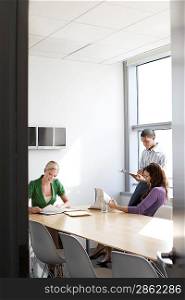 Three office workers in conference room