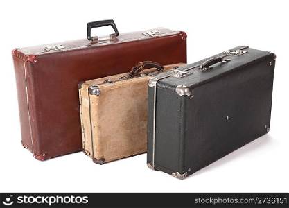 three old dirty dusty suitcase. focus on front corner of yellow suitcase. isolated