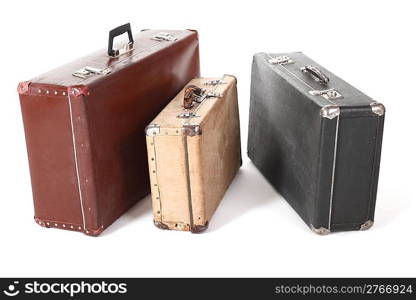 three old dirty dusty suitcase. isolated. focus on front corner of yellow suitcase.