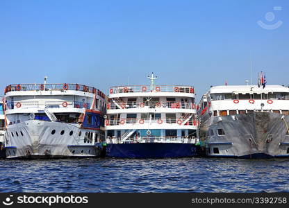 three old dirty passenger ships standing in port