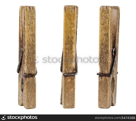 Three old wooden pegs isolated on white