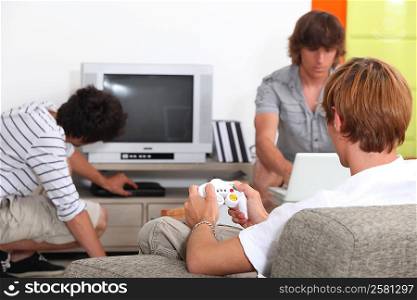 Three pals playing video games.