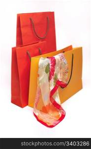 Three paper bags of different size and colours, silk scarf
