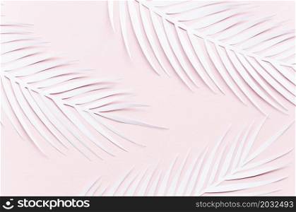 three paper palm leaves pink table