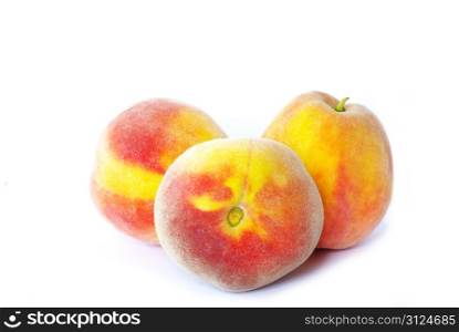 three peaches isolated on white