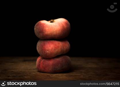 Three peaches stacked