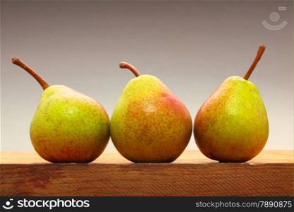 Three pears fruits on old wooden table. Healthy food organic nutrition
