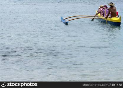 Three people canoeing in the sea, Captain Cook&acute;s Monument, Kealakekua Bay, Kona Coast, Big Island, Hawaii islands, USA