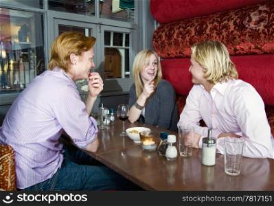 Three people chatting in a cafe