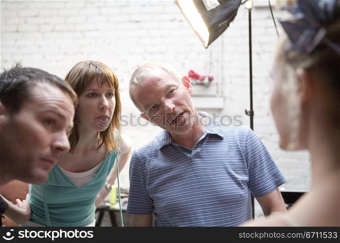 Three people looking at a woman