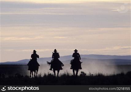 Three People Riding Horses