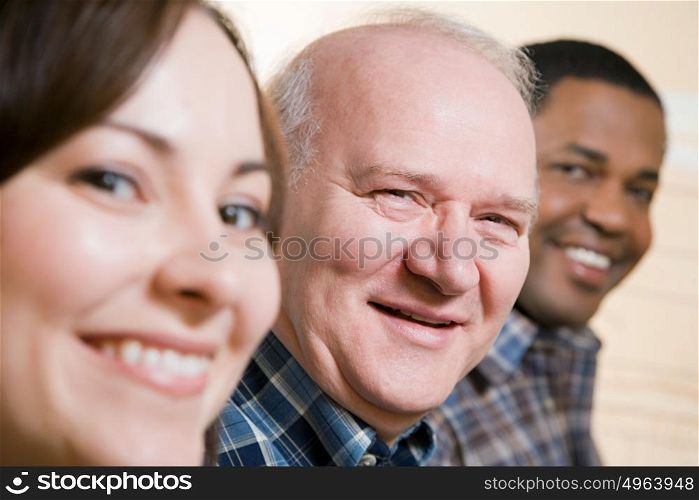 Three people smiling