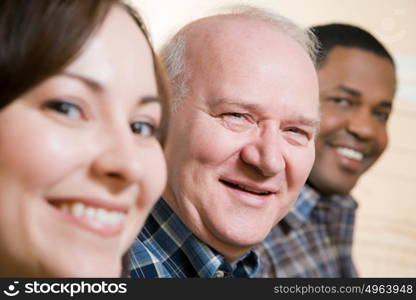 Three people smiling