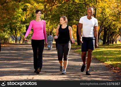 Three people walking in a park, getting some exercise
