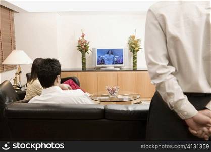 Three people watching television