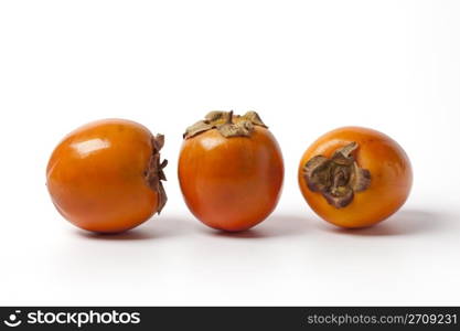 Three Persimmon, sharon, khaki, on white background