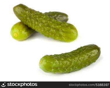 Three pickled gherkins isolated on white background