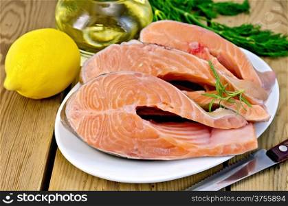 Three pieces of trout in white plate with rosemary, lemon, vegetable oil, dill on a wooden boards background